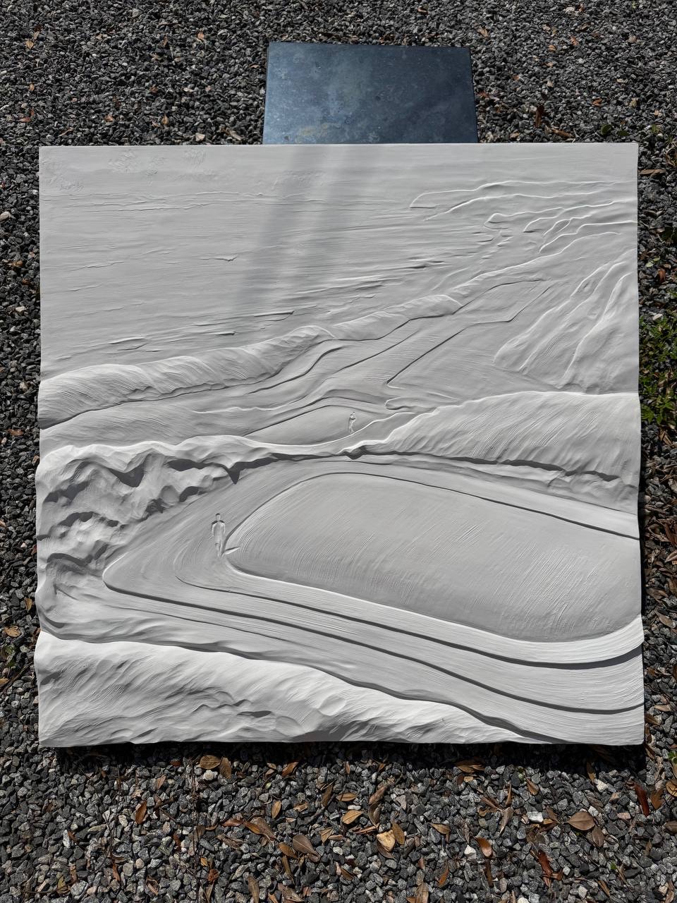 A sculpted relief of the Ballybunion golf landscape, stood outdoors on gravel.